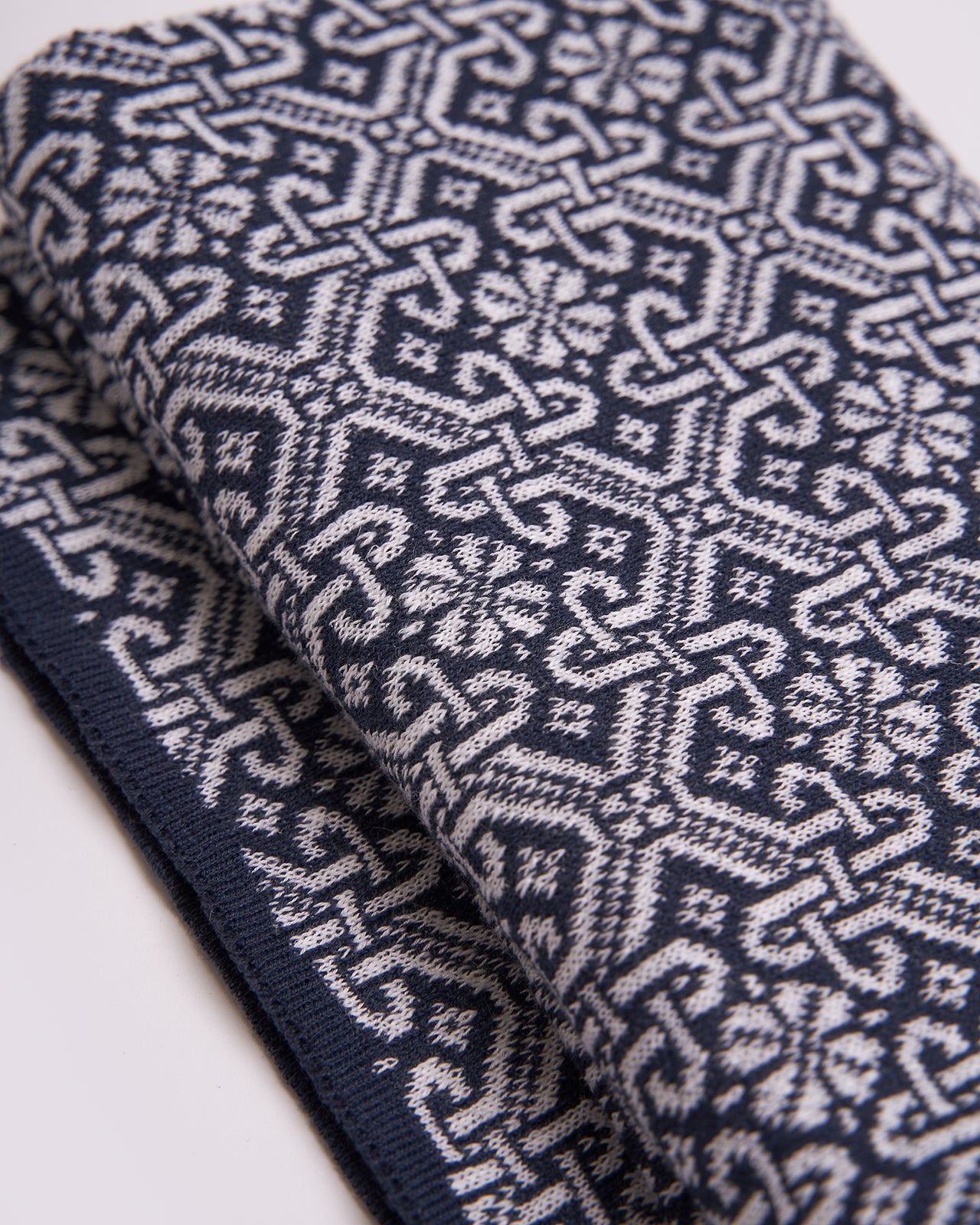 legant navy blue scarf with a detailed brown geometric pattern and solid brown edges, displayed on a white background, showcasing the intricate design and sophisticated style