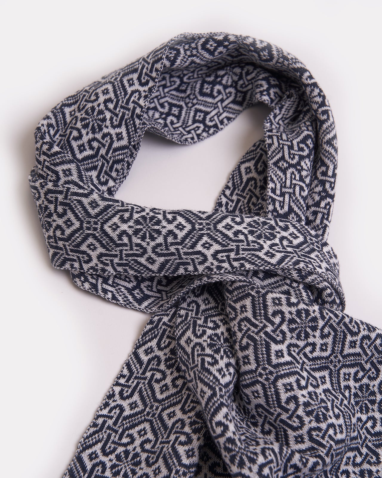 elegant navy blue scarf with a detailed brown geometric pattern and solid brown edges, displayed on a white background, showcasing the intricate design and sophisticated style