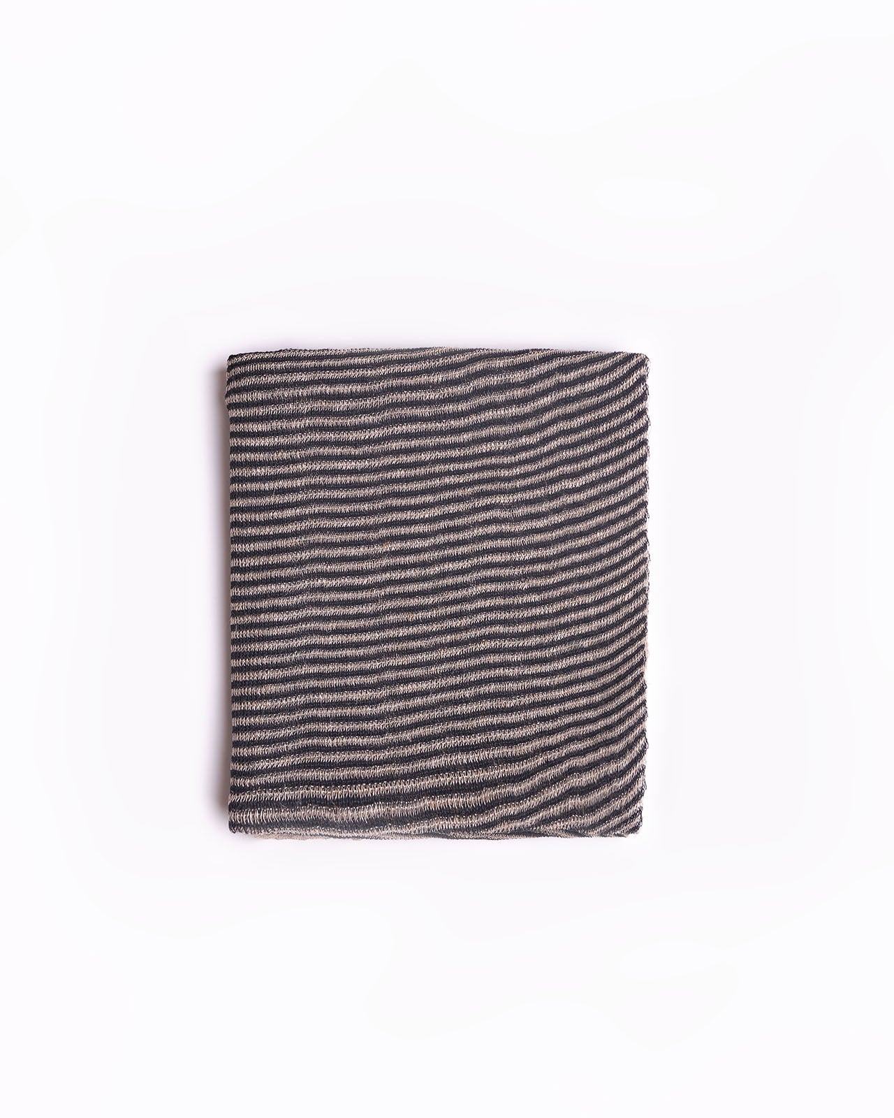 High-quality black linen striped scarf folded neatly against a clean white background. This scarf features a classic striped design in shades of beige, ideal for adding a touch of elegance to any outfit. The soft fabric and neutral tones make it a versatile accessory for both casual and formal occasions. Perfect for those searching for timeless fashion pieces